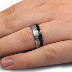 Say "I do" on your special day with this unique wavy mountain ring featuring real meteorite and fossilized dinosaur bone. The bold mountain design and ancient fossil inlay make this alternative wedding band a truly one-of-a-kind piece. You can even supply an image of your favorite mountain range to customize the shape of the meteorite mountains! RING LAYOUTRing Width: 8 mmRing Sleeve: TitaniumRing Profile: FlatRing Finish: Polished 0.5 mm Titanium3.5 mm Crushed Dinosaur Bone3.5 mm Gibeon Meteorite (Wavy Mountain Design)0.5 mm Titanium Mountains Ring, Making Rings, Gibeon Meteorite, Alternative Wedding Bands, Mountain Ring, Jewelry By Johan, Mountain Design, Dinosaur Bones, Mountain Designs