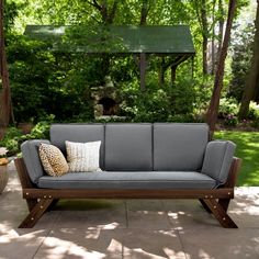 a gray couch sitting on top of a patio