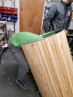 a man is working on a large piece of wood