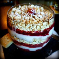 an image of a dessert in a glass bowl on the table with crackers around it