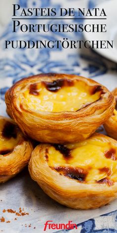 some food that is sitting on top of a blue and white table cloth with the words pastels de nata portucciesche puddinging tortills