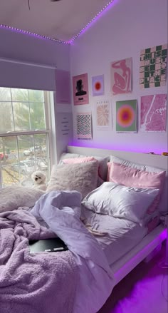 a bed room with a neatly made bed and purple lighting