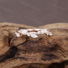 an image of a wedding ring on top of a tree branch with three diamonds in it