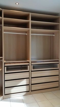 an empty walk in closet with drawers and shelves