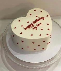 a heart shaped birthday cake on a plate