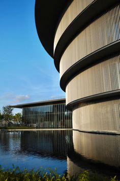 the building is next to a body of water and there are many windows on it