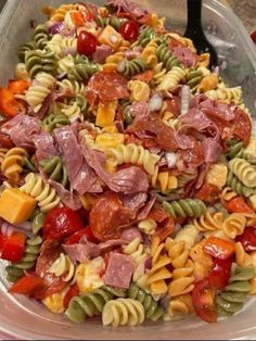 pasta salad with ham and vegetables in a plastic container