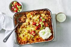 a casserole dish with meat, vegetables and sour cream