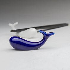 a blue and white whale figurine with chopsticks