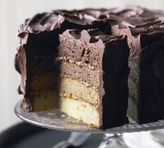 a cake with chocolate frosting sitting on top of a table