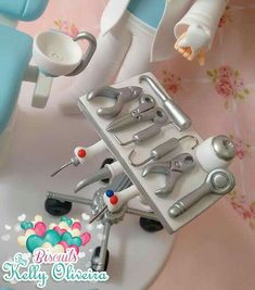 there is a toy dentist and tools in the tray on the table next to it