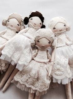 four dolls are sitting on top of each other