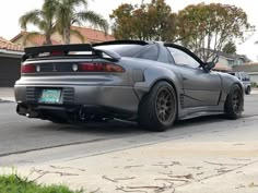 a silver sports car parked in front of a house