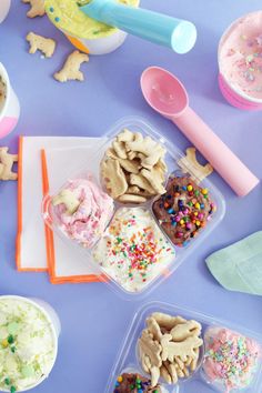 there are many treats in plastic containers on the table