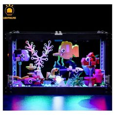 an illuminated display case filled with different types of toys and decorations in the shape of snowflakes