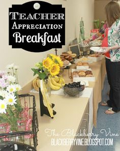 there is a woman that is serving food at the breakfast table with flowers in vases