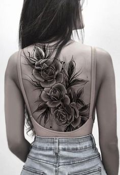 the back of a woman's body with flowers on it