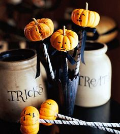 three pumpkins sitting on top of a black table