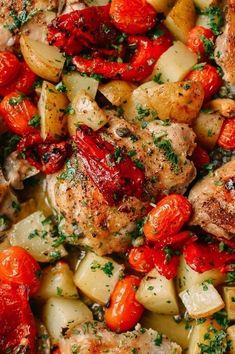 chicken, potatoes and tomatoes in a skillet with parsley on the top side