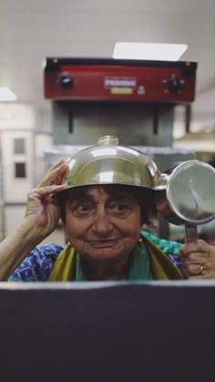 an older woman wearing a hard hat and holding a magnifying glass in front of her face