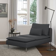 a living room scene with focus on the chaise - long sofa and floor lamp