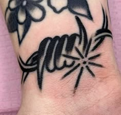 a black and white tattoo design on the wrist