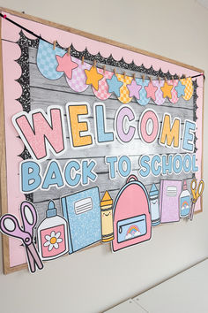 a welcome back to school sign hanging on the side of a wall in a children's room