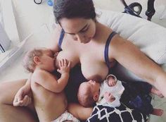 a woman is breastfeeding her baby in the middle of two other babies on a bed