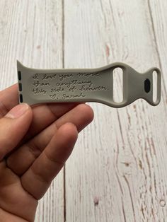 someone is holding a small bottle opener with a message on the blade and it says, i love you more than anything else