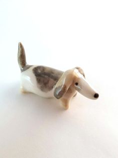 a dog figurine sitting on top of a white table