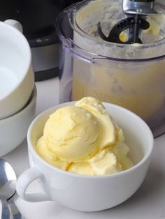 a bowl filled with ice cream next to a blender