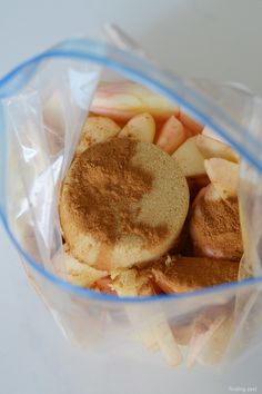 a bag filled with apples and cinnamon on top of a table