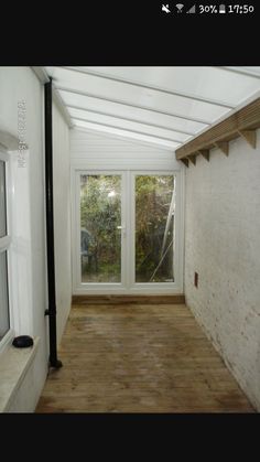 an empty room with wooden floors and white walls