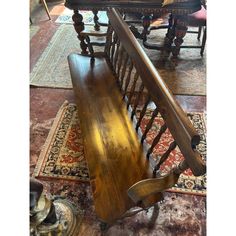 a wooden bench sitting on top of a carpeted floor