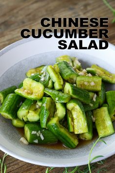 chinese cucumber salad in a white bowl on a wooden table with text overlay