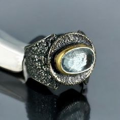 This ring has a very luminous and peaceful aquamarine in it.  The comfortable band has my beautiful hallmark textured with a comfy fit for all fingers including those that have a little waist or slightly big knuckles as this ring will sit comfortably in the narrow of your finger. It won't spin around either. It has a beautiful natural bark style pattern. The bezel around the stone is 22kt gold fused to sterling silver with a method called kumboo. This ring is about a size 8 but can be sized to a Aquamarine Ring, Aquamarine Rings, Ring Sterling Silver, Comfy Fits, Rings Statement, Aquamarine, Jewelry Ideas, Hallmark, The Stone