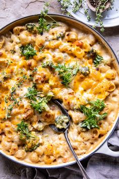 a skillet filled with macaroni and cheese topped with parsley on top