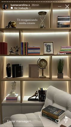 a white chair sitting in front of a book shelf filled with books