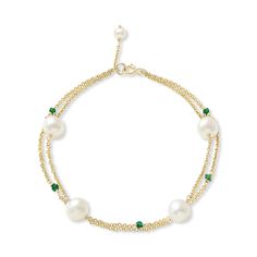 A delicate cultured freshwater pearl fine chain bracelet with a modern twist.    This elegant bracelet combines almost round cultured freshwater pearls with emerald gemstones to create a stunning piece to be worn day or night.  The perfect gift for a May birthday baby as emerald is their birthstone.  Non-tarnish gold style chain bracelet with almost round cultured freshwater pearls & emerald gemstones on a gold plated sterling silver lobster clasp.  Please note pearls are organic and may vary in Elegant Double Strand Bracelet With Delicate Chain, Elegant Pearl Drop Jewelry For May Birthstone, Elegant Pearl Bracelets With Delicate Chain, Elegant Gold Beaded Bracelets With May Birthstone, Elegant May Birthstone Bracelet With Adjustable Chain, Luxury Pearl Bracelet With Pearl Chain, Emerald And Pearl Bracelet, Everyday Gold Hand-strung Pearl Bracelet, Adjustable Green Pearl Bracelet