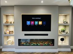 a flat screen tv mounted on the wall above a fireplace