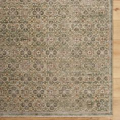 an antique rug on wooden flooring in a room