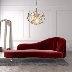 a red couch sitting on top of a rug next to a mirror