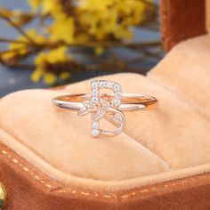 a diamond ring sitting on top of a velvet box