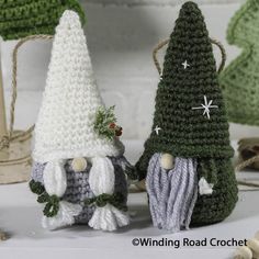 two crocheted gnomes standing next to each other