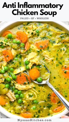 a white bowl filled with chicken and carrots next to a spoon full of soup