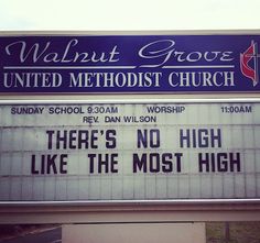 there's no high like the most high church sign in front of a building