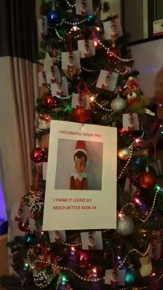 a christmas tree has been decorated with pictures and cards for someone to put on it