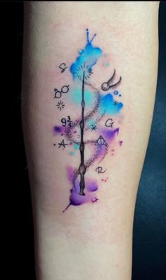 a watercolor tattoo on the leg of a woman with a clock and stars in it