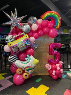 a number five balloon sculpture with balloons and toys