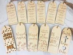 wooden bookmarks with names and hearts are laid out on a white marble countertop